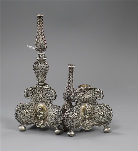 A pair of filligree white metal and red stone set candlestick? bases (a.f.), 17.4cm.